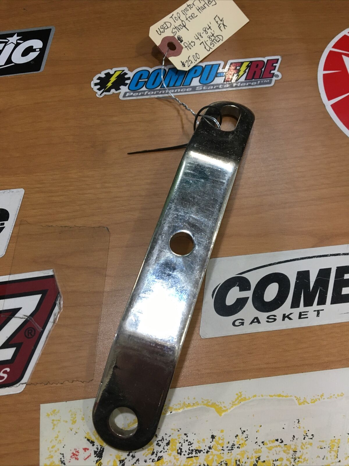 Top motor mount strap for Harley